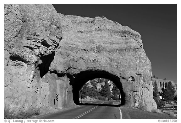 Road tunnel in pink limestone cliff. Utah, USA