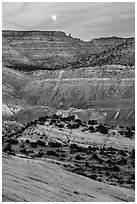 Moon rising over colorful rocks of the Cockscomb. Grand Staircase Escalante National Monument, Utah, USA ( black and white)