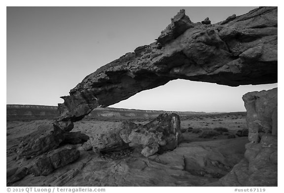 Slender and jagged Sunset Arch and the Straight Cliffs, sunrise. Grand Staircase Escalante National Monument, Utah, USA (black and white)