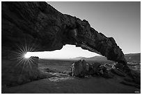 Sunstar through Sunset Arch. Grand Staircase Escalante National Monument, Utah, USA ( black and white)