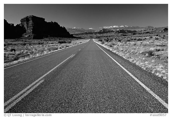 Road, sandstone cliffs, snowy mountains. Utah, USA (black and white)