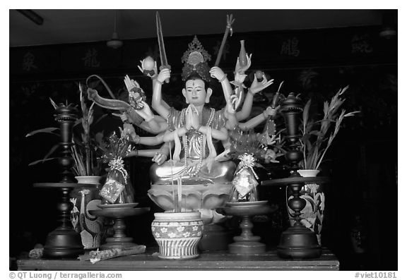 Altar with a multiple-armed buddhist statue. Ho Chi Minh City, Vietnam