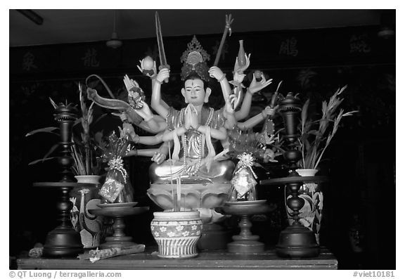 Altar with a multiple-armed buddhist statue. Ho Chi Minh City, Vietnam