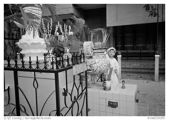 Kid in mourning dress at an outdoor altar, Xa Loi pagoda, district 3. Ho Chi Minh City, Vietnam (black and white)