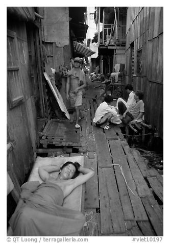 Sleeping late in a narrow alley. Ho Chi Minh City, Vietnam (black and white)