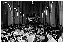 Crowds exit the Cathedral St Joseph at the end of the Christmas mass. Ho Chi Minh City, Vietnam ( black and white)