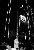 Child with christmas hat in front of St Joseph Cathedral on Christmas eve. Ho Chi Minh City, Vietnam (black and white)