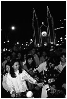 Women on motorbike in front of St Joseph Cathedral on Christmas eve. Ho Chi Minh City, Vietnam (black and white)