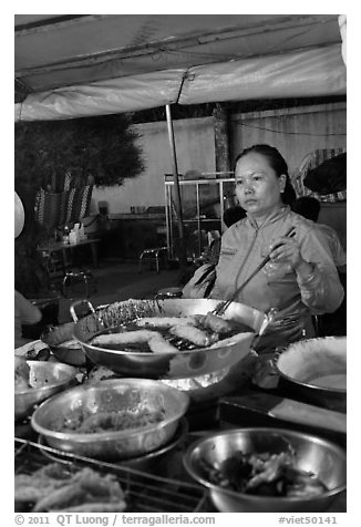 Woman preparing food, Dinh Cau Night Market. Phu Quoc Island, Vietnam (black and white)