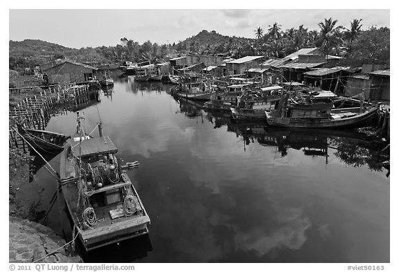 Fishing boats along dark river. Phu Quoc Island, Vietnam (black and white)