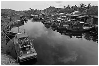 Fishing boats along dark river. Phu Quoc Island, Vietnam (black and white)