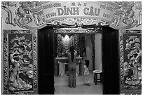 Woman with girl worshipping at Dinh Cau temple, Duong Dong. Phu Quoc Island, Vietnam (black and white)