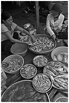 Customer purchasing fish at market, Duong Dong. Phu Quoc Island, Vietnam (black and white)