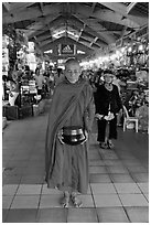 Buddhist Monk doing alms round in Ben Thanh Market. Ho Chi Minh City, Vietnam (black and white)