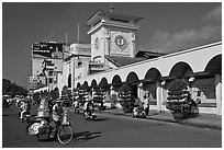 Food vendor riding outside Ben Thanh Market. Ho Chi Minh City, Vietnam (black and white)