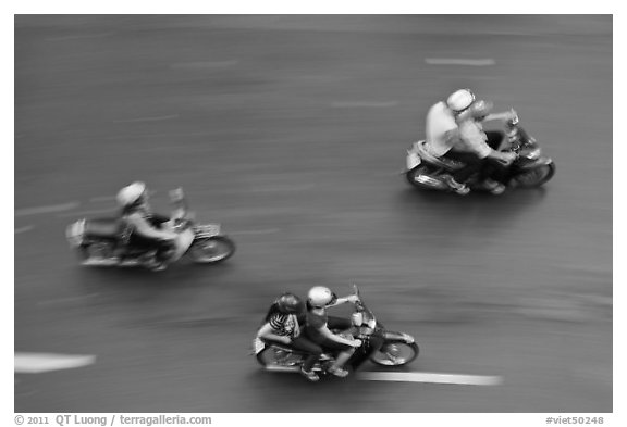 Motorbike riders seen from above with speed blur. Ho Chi Minh City, Vietnam