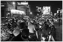 Motorbikes waiting at traffic light at night. Ho Chi Minh City, Vietnam (black and white)