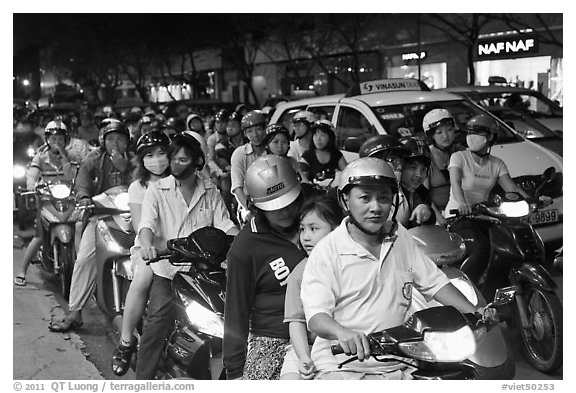 Riders waiting for traffic light at night. Ho Chi Minh City, Vietnam