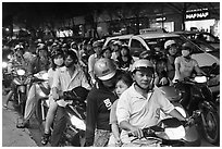 Riders waiting for traffic light at night. Ho Chi Minh City, Vietnam (black and white)