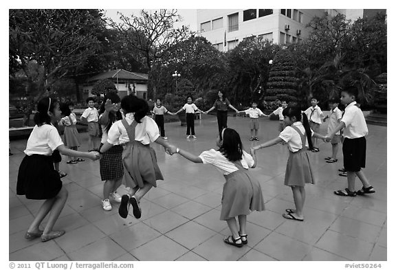 Children playing in circle in park. Ho Chi Minh City, Vietnam