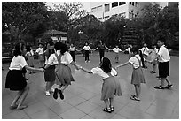 Children playing in circle in park. Ho Chi Minh City, Vietnam (black and white)