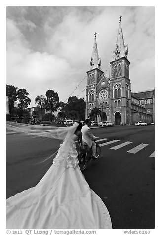 Bride with flowing dress in front of Cathedral. Ho Chi Minh City, Vietnam