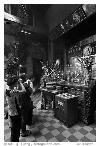 Women at altar, Phuoc Hai Tu temple, district 3. Ho Chi Minh City, Vietnam