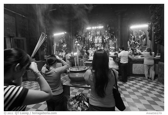 Worshipping at altar with  Jade Emperor and Four Big Diamonds, Chua Ngoc Hoang, district 3. Ho Chi Minh City, Vietnam (black and white)