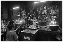 Man lightening candles, Jade Emperor Pagoda, district 3. Ho Chi Minh City, Vietnam ( black and white)