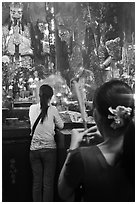 Women holding incense sticks, Phuoc Hai Tu pagoda, district 3. Ho Chi Minh City, Vietnam (black and white)