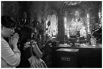 Women worshipping Thang Hoang, Phuoc Hai Tu pagoda, district 3. Ho Chi Minh City, Vietnam ( black and white)