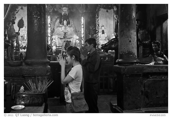Couple worshipping Thang Hoang, Chua Ngoc Hoang pagoda, district 3. Ho Chi Minh City, Vietnam (black and white)