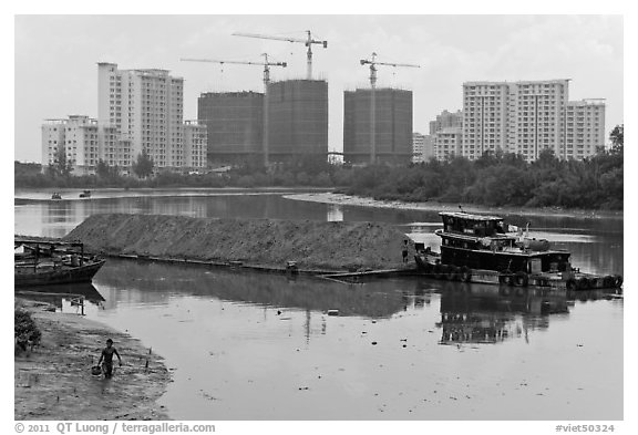 River scene and high rise towers in construction, Phu My Hung, district 7. Ho Chi Minh City, Vietnam