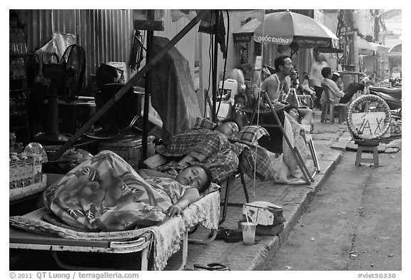 Vendors sleeping on the street at dawn. Ho Chi Minh City, Vietnam