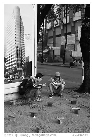 Men having breakfast on a sidewalk. Ho Chi Minh City, Vietnam