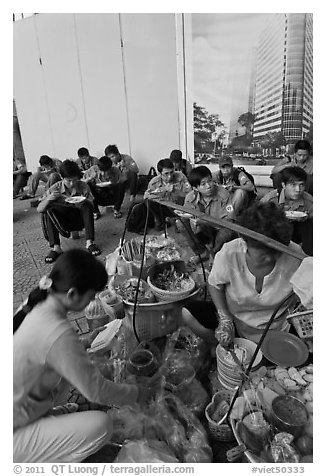 Food vendor preparing breakfast on the street. Ho Chi Minh City, Vietnam (black and white)