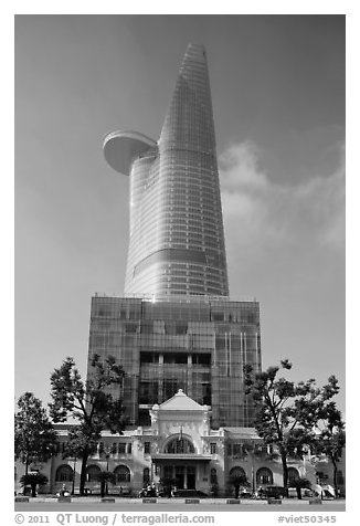 Bitexco Tower (tallest in the city) dwarfing colonial-area building. Ho Chi Minh City, Vietnam (black and white)