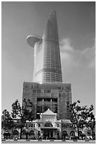 Bitexco Tower (tallest in the city) dwarfing colonial-area building. Ho Chi Minh City, Vietnam (black and white)