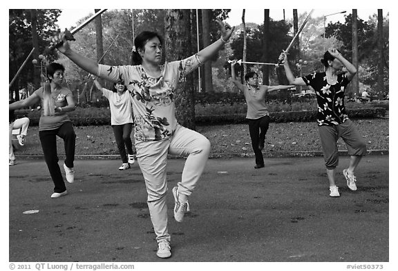 People practicisng Tai Chi with swords, Cong Vien Van Hoa Park. Ho Chi Minh City, Vietnam