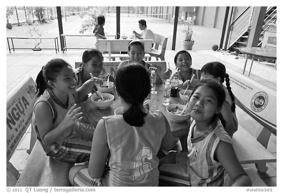 Girls athetics team eating, Cong Vien Van Hoa Park. Ho Chi Minh City, Vietnam (black and white)