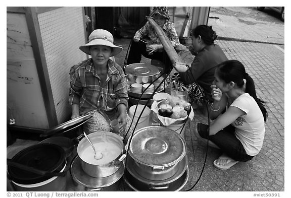 Woman offering soft tofu on the street. Ho Chi Minh City, Vietnam (black and white)