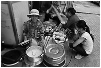 Woman offering soft tofu on the street. Ho Chi Minh City, Vietnam (black and white)