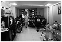 Living room used as car and motorbike garage. Ho Chi Minh City, Vietnam (black and white)