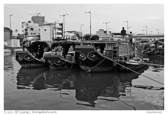 Mariners on freight boats with traditional painted eyes, Saigon Arroyau. Cholon, Ho Chi Minh City, Vietnam (black and white)