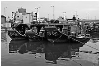 Mariners on freight boats with traditional painted eyes, Saigon Arroyau. Cholon, Ho Chi Minh City, Vietnam ( black and white)