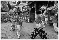 Dancers carry dragon on poles, Thien Hau Pagoda. Cholon, District 5, Ho Chi Minh City, Vietnam (black and white)