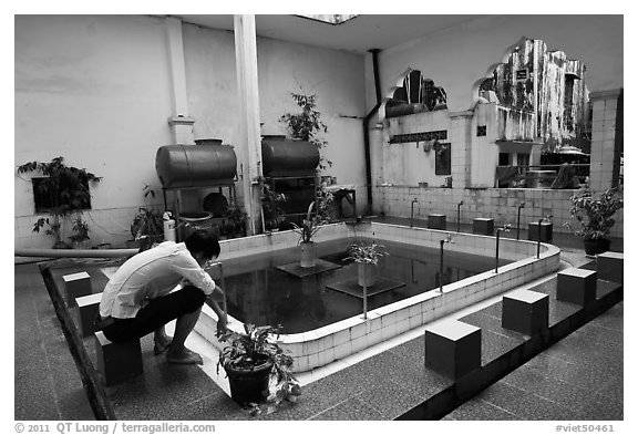 Man sitting in mosque pool, Cholon Mosque. Cholon, District 5, Ho Chi Minh City, Vietnam (black and white)