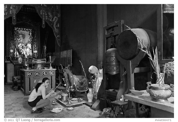 Woman worshipping Quan Cong sacred red horse, Tam Son Hoi Quan Pagoda. Cholon, District 5, Ho Chi Minh City, Vietnam (black and white)