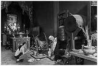 Woman worshipping Quan Cong sacred red horse, Tam Son Hoi Quan Pagoda. Cholon, District 5, Ho Chi Minh City, Vietnam (black and white)