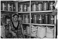 Woman with jars of traditional medicinal supplies. Cholon, Ho Chi Minh City, Vietnam ( black and white)